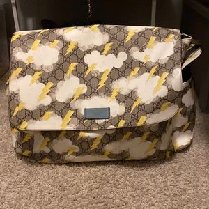 Gucci lighting bult diaper bag comes with a gucci imprint diaper changer.